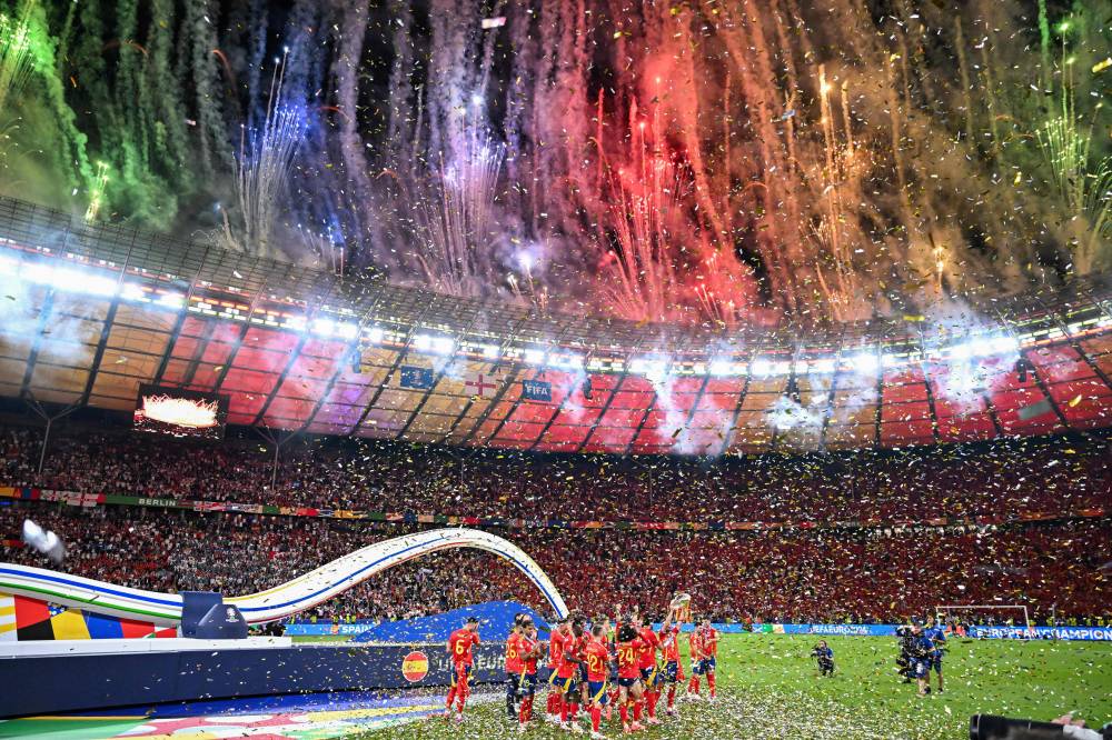 Spain's players celebrate with the trophy after winning the UEFA Euro 2024 final football match between Spain and England at the Olympiastadion in Berlin on July 14, 2024. (Photo by AFP)