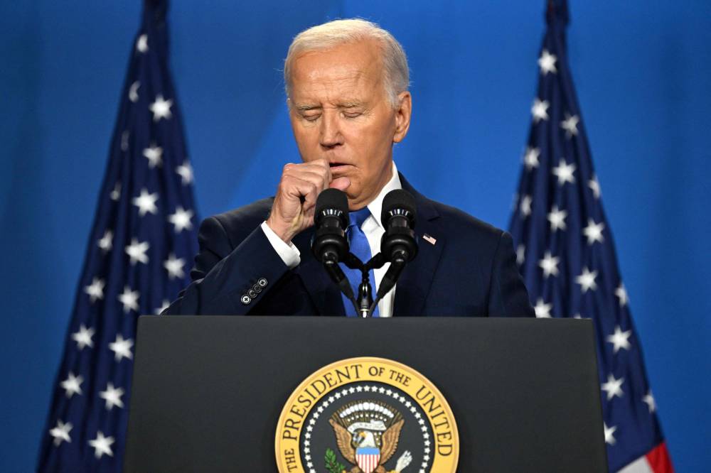 (FILES) US President Joe Biden coughs as he speaks during a press conference at the close of the 75th NATO Summit at the Walter E. Washington Convention Center in Washington, DC on July 11, 2024. - Photo by AFP