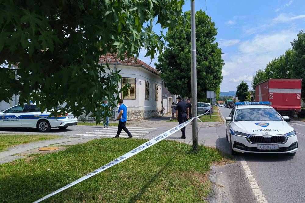 Police cars are stationed in front of a retirement home where at least five people were killed in a shooting. Photo by Nikola Blazekovic/AFP