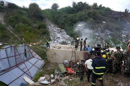 Rescue operations are underway at the accident site after a Saurya Airlines' plane crashed during takeoff at the Tribhuvan International Airport in Kathmandu. Photo by Prabin Ranabhat/AFP.