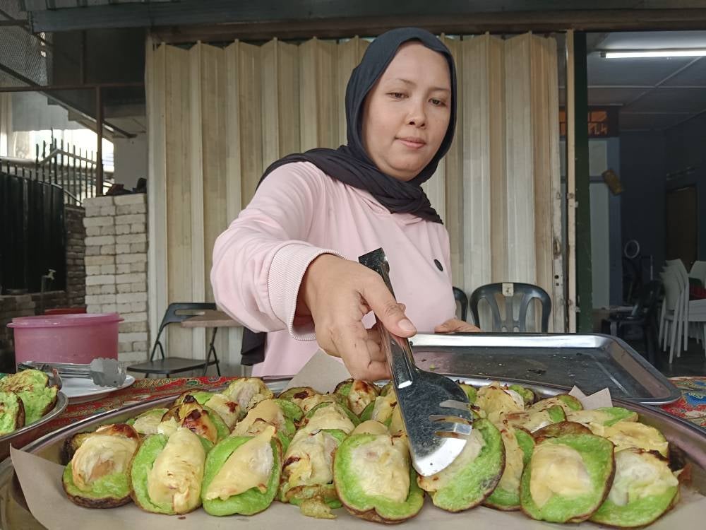 Abd Malik's customers, including tourists, are flocking to his stall as they find his delicacy a unique treat. - Photo by Bernama