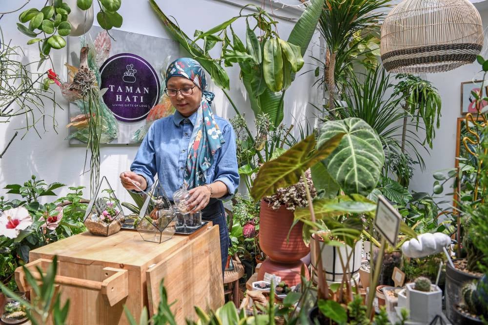 Owner of Taman Hati, Suzana Zainal Abidin, 53, making a terrarium. Photo by Bernama