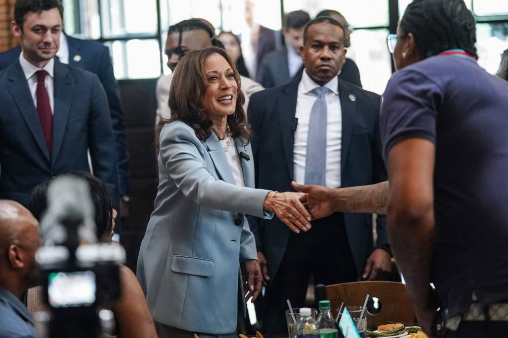 US Vice President and 2024 Democratic presidential candidate Kamala Harris greets people during a campaign stop at Paschal's, a historic Black-owned restaurant, in Atlanta, Georgia, on July 30, 2024. (Photo by Elijah Nouvelage / POOL / AFP)