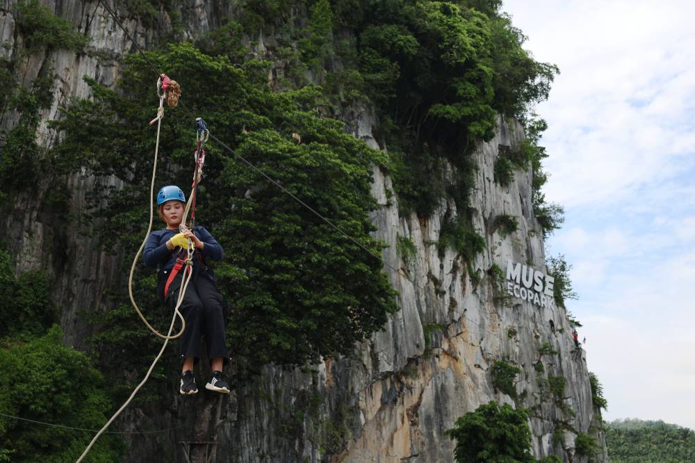 Once they get to the platform, climbers then take part in the flying fox activity from a height of 40 metres before landing on the Muse Ecopark field. Photo by Bernama