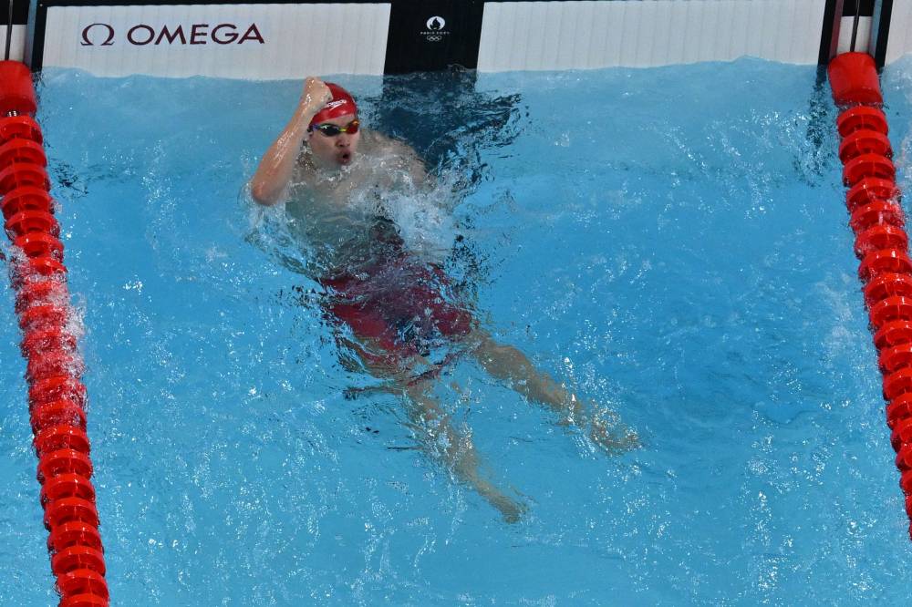 China's Pan Zhanle celebrates after winning the final of the men's 100m freestyle swimming event during the Paris 2024 Olympic Games at the Paris La Defense Arena in Nanterre, west of Paris, on July 31, 2024. (Photo by AFP)