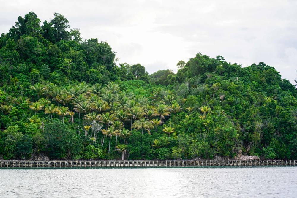 This photo taken on July 3, 2024 shows a general view of the mile-long wooden jetty that connects the Bajau village of Pulau Papan with the island of Malenge as seen in the Togean Islands in Sulawesi. - Photo by AFP
