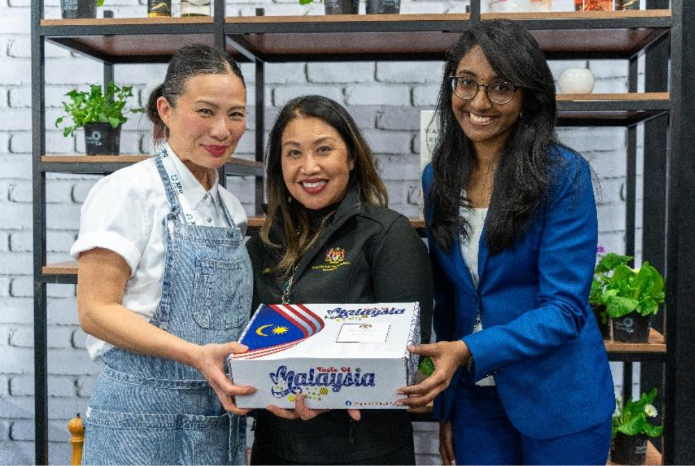 Presenting Malaysian products to Poh Ling Yeow, celebrity chef from Masterchef Australia, during the Food Show in Auckland, New Zealand.