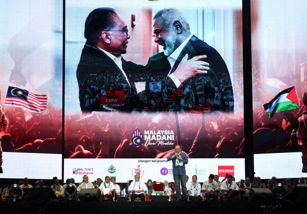 Prime Minister Datuk Seri Anwar Ibrahim delivering a speech at the peak event of the 'Himpunan Pembebasan Palestine' at Axiata Arena, yesterday. - Photo by Bernama