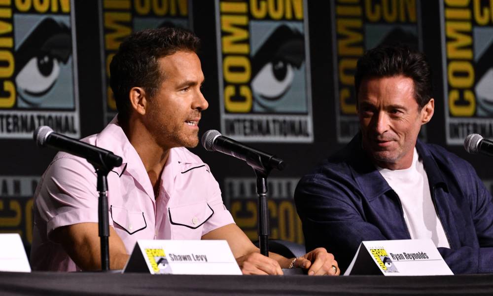 Canadian actor Ryan Reynolds (L) and Australian actor Hugh Jackman speak on stage during “Deadpool and Wolverine” celebration of life fan event during Comic Con International in San Diego, California, July 25, 2024. (Photo by Chris DELMAS / AFP)
