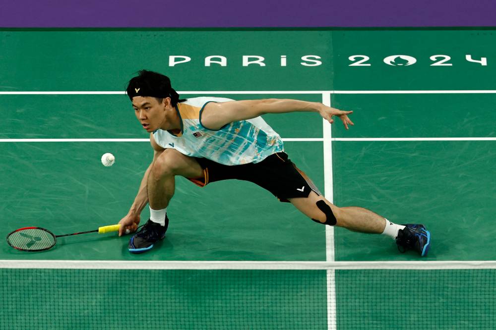 Malaysia's Lee Zii Jia plays a shot to India's Lakshya Sen in their men's singles badminton bronze medal match during the Paris 2024 Olympic Games at Porte de la Chapelle Arena in Paris on August 5, 2024. (Photo by Luis TATO / AFP)