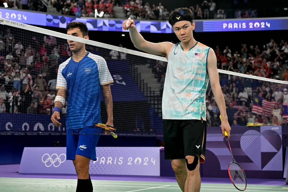 Malaysia's Lee Zii Jia reacts after winning the men's singles badminton bronze medal match during the Paris 2024 Olympic Games at Porte de la Chapelle Arena in Paris on Aug 5, 2024. - (Photo by ARUN SANKAR / AFP)