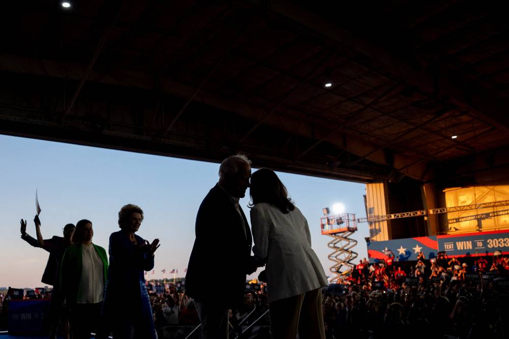 Democratic presidential candidate, US Vice President Kamala Harris is joined on stage by Democratic vice presidential candidate Minnesota Gov. Tim Walz during a campaign event at Detroit Metropolitan Wayne County Airport on August 7, 2024 in Detroit, Michigan. - Photo by AFP
