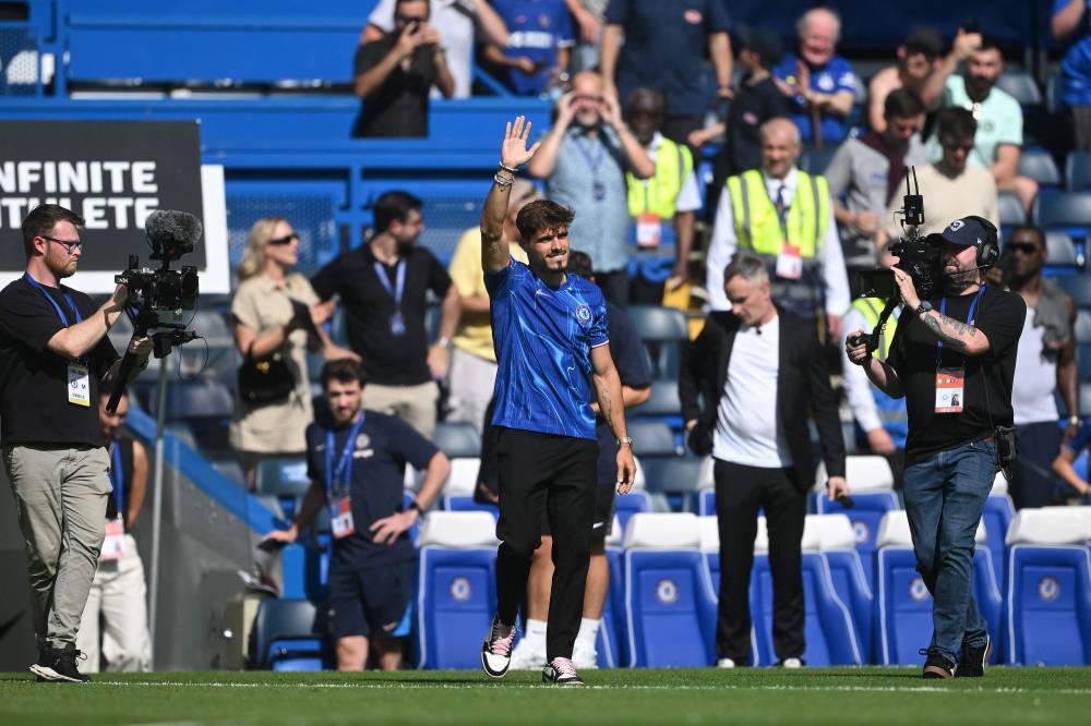 Chelsea's new signing Portuguese midfielder Pedro Neto waves to the fans at half-time, in the pre-season friendly football match between Chelsea and Inter Milan at the Stamford Bridge stadium in London on August 11, 2024. (Photo by AFP)