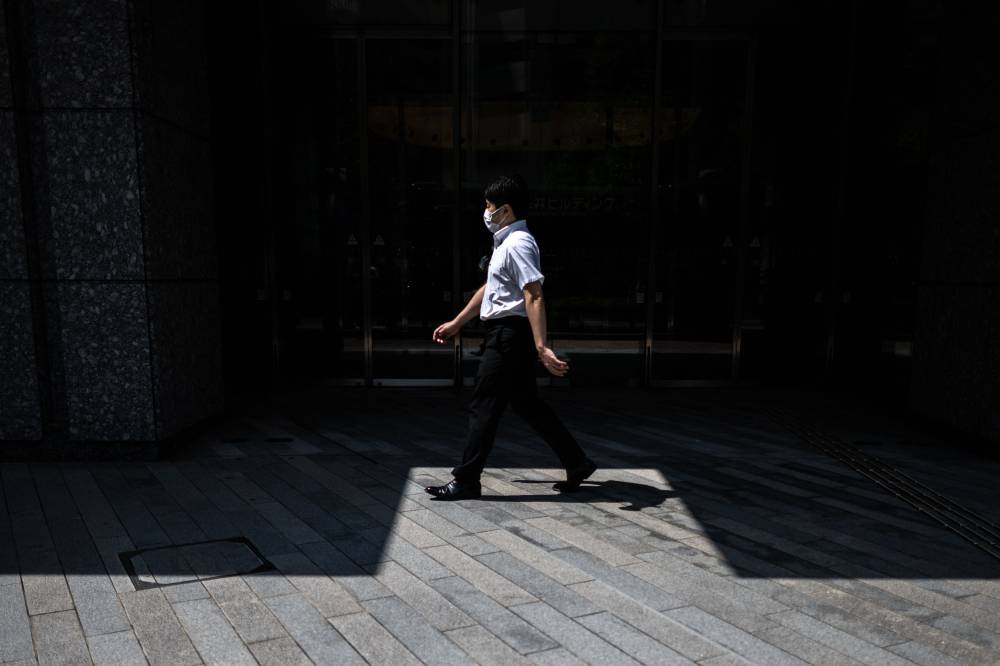 A man walks in Ginza district of Tokyo on August 9, 2024. Photo for illustration purpose only. (Photo by AFP)