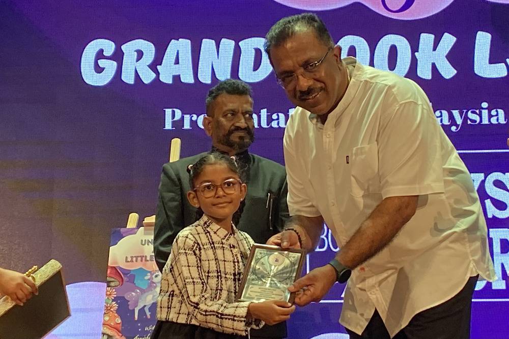 Aayushi (left) and Gunaraj at the book launch ceremony of Ayushi's book, 'Unicorn and Little Amanda' at Raja Tun Uda Library, Shah Alam.