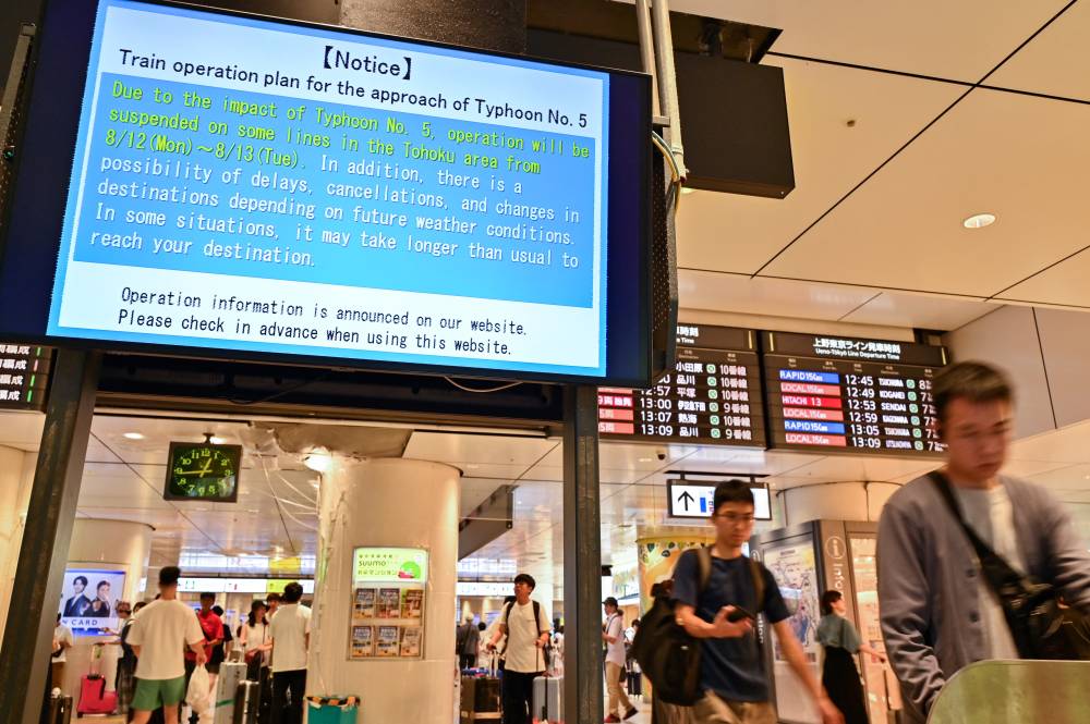 A digital sign alerting passengers of possible delays in northern Japan - due to "Typhoon No. 5", now classified as Severe Tropical Storm Maria - is pictured at an entrance to Japan Rail at Tokyo Station in central Tokyo on Aug 12, 2024. - (Photo by Richard A. Brooks / AFP)