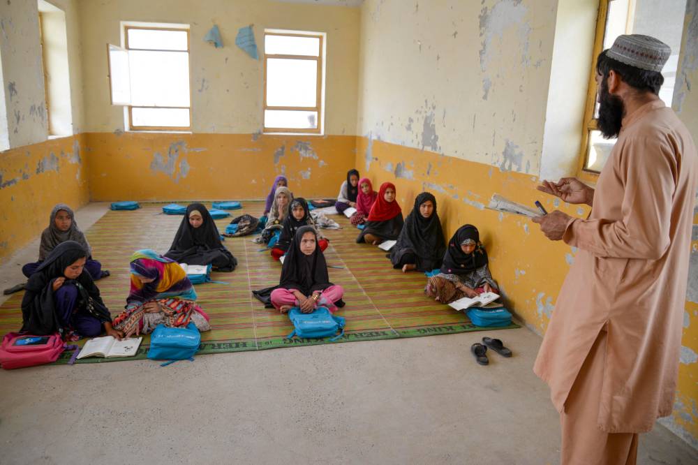 Afghan girls sit in a class at a primary school in Panjwai district of Kandahar province on May 16, 2024. - (Photo by SANAULLAH SEIAM / AFP)
