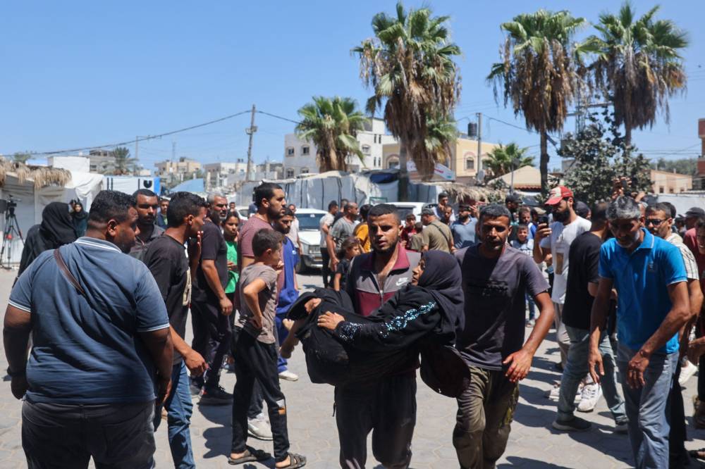 Palestinians transport people injured in Israeli bombardment to the Al-Aqsa Martyrs hospital in Deir el-Balah. Photo by Eyad Baba/AFP