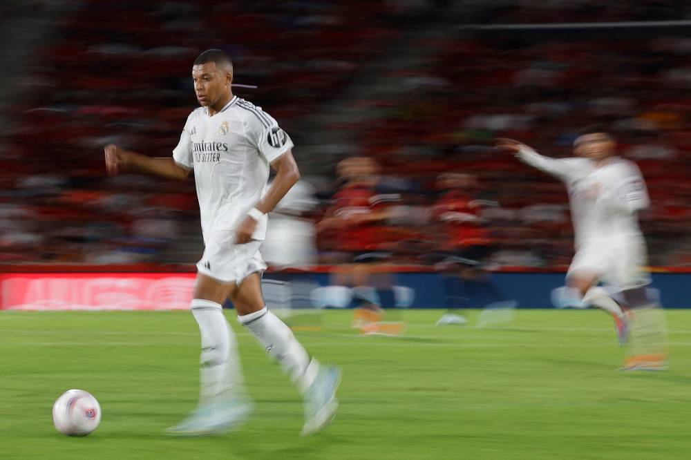 Real Madrid's French forward #09 Kylian Mbappe controls the ball during the Spanish league football match between RCD Mallorca and Real Madrid CF at the Mallorca Son Moix stadium in Palma de Mallorca on August 18, 2024. (Photo by AFP)