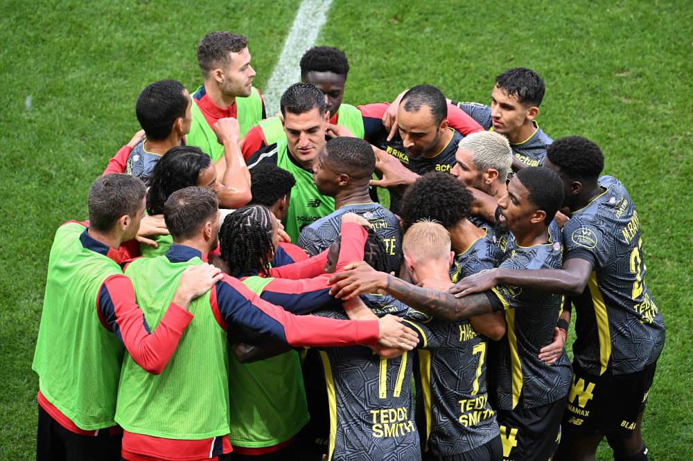 Lille's players celebrate after Lille's French defender #18 Bafode Diakite (C) scored his team's first goal during the French L1 football match between Stade de Reims and Lille LOSC at the Stade Auguste-Delaune in Reims, northern France, on August 17, 2024. (Photo by AFP)