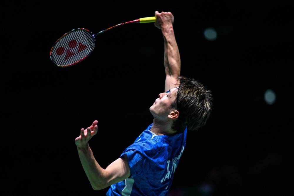 Japan's Takuma Obayashi hits a return against Malaysia's Leong Jun Hao during their men's singles match on the second day of the Japan Open badminton tournament at Yokohama Arena in Yokohama, Kanagawa prefecture, south of Tokyo on August 21, 2024. (Photo by AFP)