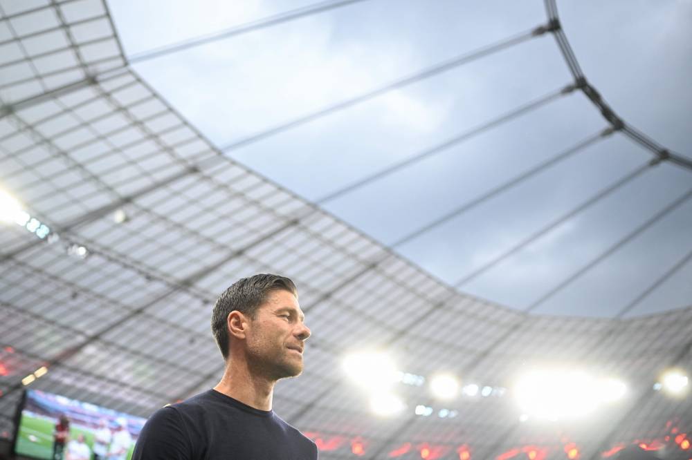 Bayer Leverkusen's Spanish head coach Xabi Alonso arrives for the German Supercup football match between Bayer 04 Leverkusen and VfB Stuttgart in Leverkusen, western Germany on August 17, 2024. (Photo by AFP)