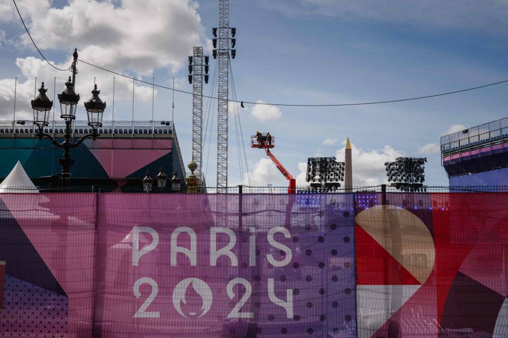 Construction workers operate on the Place de la Concorde Paralympic site in Paris, on August 21, 2024, ahead of the Paris 2024 Paralympic Games. - Photo by AFP