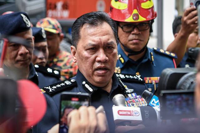 Kuala Lumpur police chief Datuk Rusdi Mohd Isa (second from left) speaks during a press conference regarding a woman, who is an Indian national believed to have fallen about 10 metres and was buried in a sinkhole at Masjid India, Kuala Lumpur, around 8am, today. - Photo by Bernama