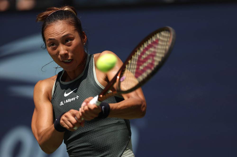 Qinwen Zheng of China returns against Amanda Anisimova of the United States during their Women's Singles First Round match on Day One of the 2024 US Open at the USTA Billie Jean King National Tennis Center on August 26, 2024 in the Flushing neighborhood of the Queens borough of New York City. - Photo by AFP