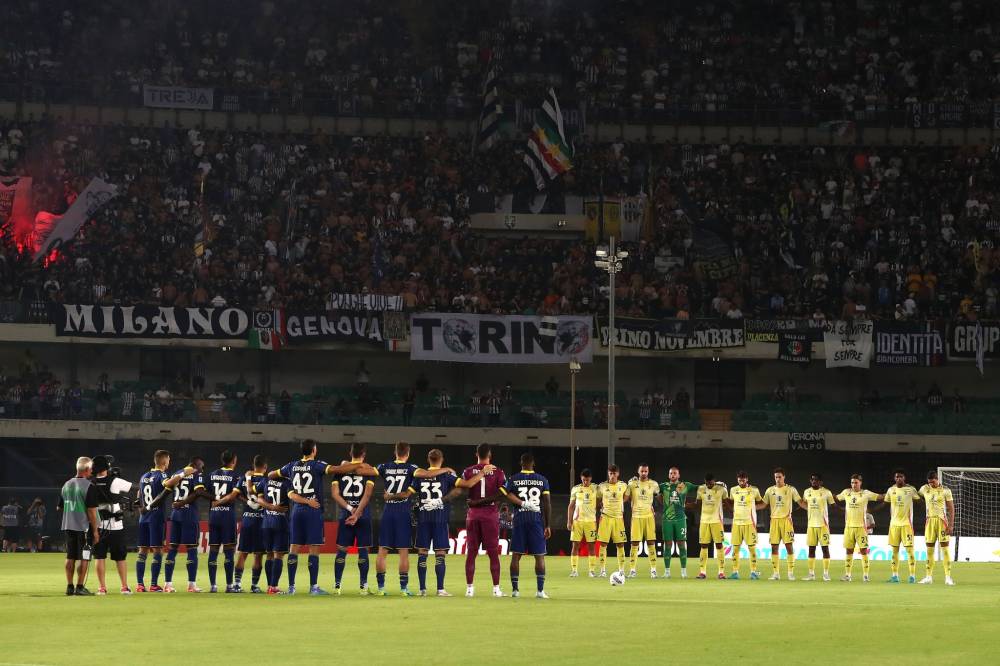 Players of Hellas Verona and Juventus during the minute of silence during the Serie A match between Hellas Verona and Juventus at Stadio Marcantonio Bentegodi on August 26, 2024 in Verona, Italy. (Photo by Juventus FC/Juventus FC via Getty Images)