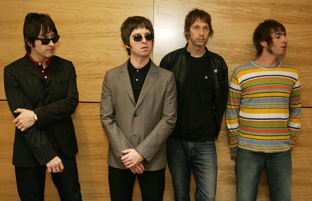 (FILES) Gem (L), Noel Gallagher (2L), Andy Bell (2R) and Liam Gallagher, members of the British rock band "Oasis" hold a photocall in Hong Kong on February 25, 2006. (Photo by Mike CLARKE / AFP)