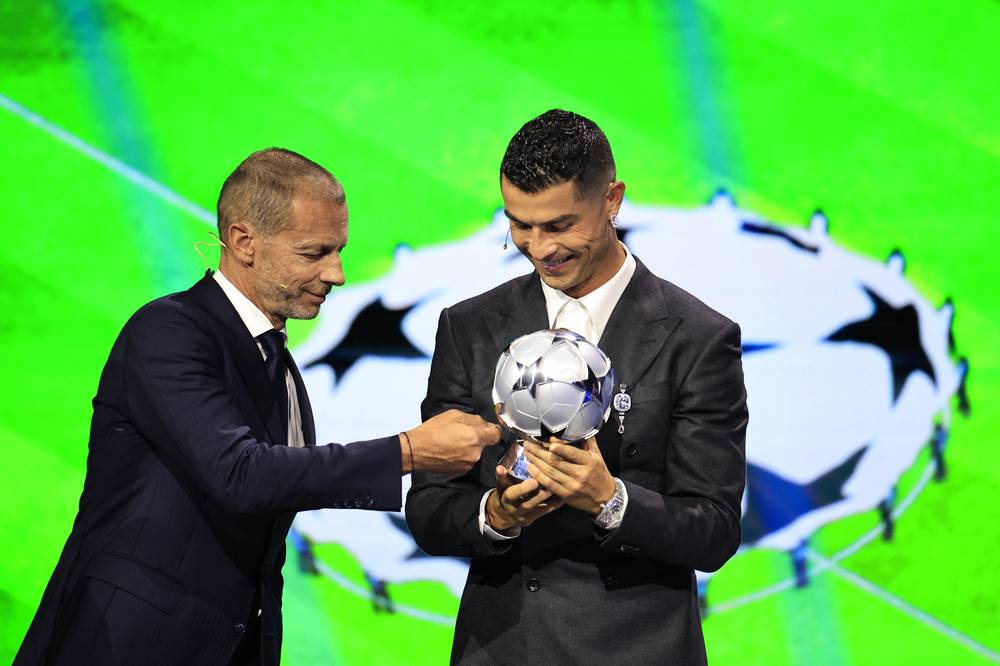 Portugal's national team and Saudi Al-Nassr's captain Cristiano Ronaldo (right) receives the All-Time Goalscorer Award in the UCL from UEFA President Aleksander Ceferin during the ceremony of the draw for the group stage of the 2024-2025 UCL football tournament, at the Grimaldi Forum in Monaco on Aug 29. (Photo by AFP)