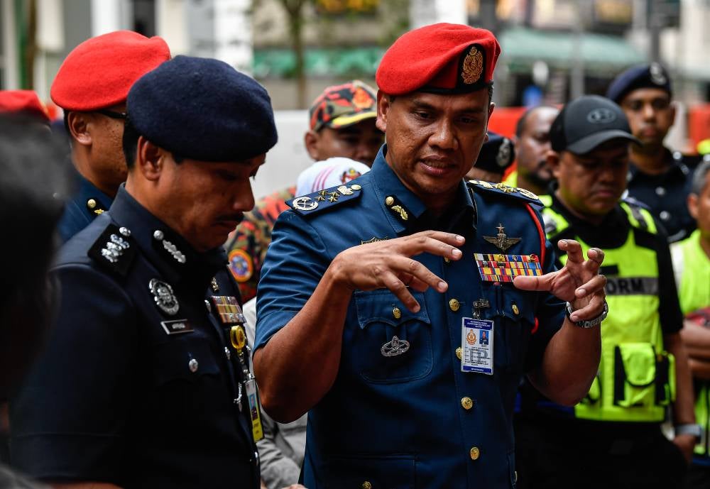JBPM director-general Datuk Nor Hisham Mohammad (right) with Dang Wangi district police chief ACP Sulizmie Affendy Sulaiman (left) during a press conference, yesterday on the incident where an Indian national was swallowed by a sinkhole on Jalan Masjid India in Kuala Lumpur. - Photo by Bernama