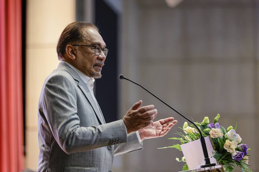 Prime Minister and Finance Minister Datuk Seri Anwar Ibrahim delivering his speech at the Finance Ministry Staff Gathering, today. - Photo by Bernama