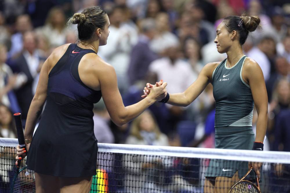 Aryna Sabalenka (L) of Belarus shakes hands with Zheng Qinwen of China following their Women's Singles Quarterfinal match on Day Nine of the 2024 US Open at USTA Billie Jean King National Tennis Centre on September 3 in the Flushing neighbourhood of the Queens borough of New York City. - Photo by AFP