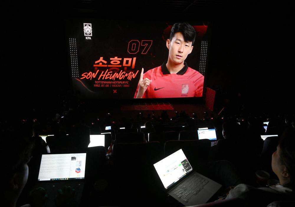 South Korea's national football team player Son Heung-min is seen on a screen during a press conference to announce the South Korean squad for the Asian Cup in Seoul on Dec 28, 2023. - (Photo by Jung Yeon-je / AFP) 
