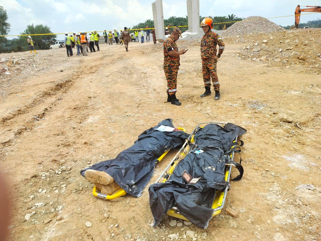 The victims were buried by earth and concrete of the U box culvert while they were doing drainage construction work. Photo courtesy of Fire and Rescue Department 