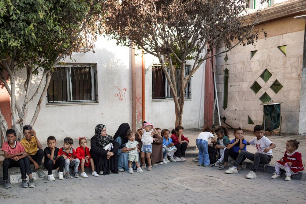 People wait with children for polio vaccinations in Khan Yunis in the southern Gaza Strip on Sep 5, 2024 amid the ongoing war in the Palestinian territory between Israel and Hamas. (Photo by BASHAR TALEB / AFP)