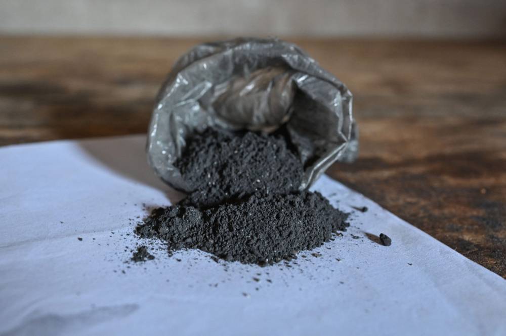 A general view of a black powder, apparently composed of plants and human flesh (a clitoris cut from a girl subjected to female genital mutilation), is seen in the village of Kamassela near Touba on July 10, 2024. - Photo by AFP