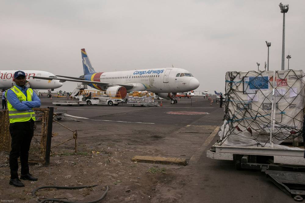 This handout photograph taken and released by the European Union's Press Service on September 5, 2024, an official stands next to the batch of mpox vaccines donated by European Union at the tarmac of the Kinshasa International Airport in the Nsele district of Kinshasa. - Photo by AFP