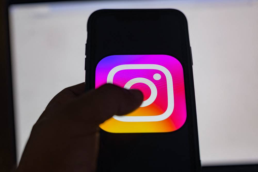 This picture taken in Istanbul on Aug 2, 2024, shows the logo of the social network Instagram on a smartphone. - (Photo by YASIN AKGUL / AFP)