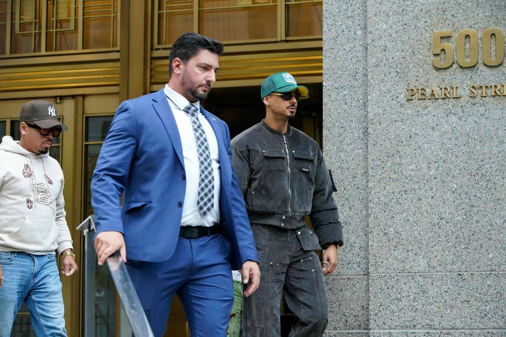 Quincy Brown (R), stepson of rapper and music producer Sean "Diddy" Combs, exits federal court after his stepfather's arraignment hearing on September 17, 2024, in New York. - Photo by AFP