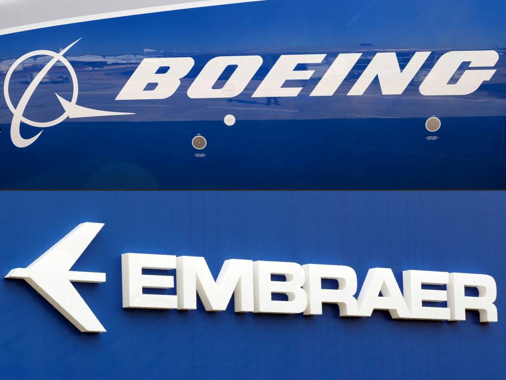 (FILES) (COMBO) This combination of file pictures created on December 21, 2017 shows the Boeing logo on the fuselage of a Boeing 787-10 Dreamliner test plane presented on the tarmac of Le Bourget airport near Paris on June 18, 2017, and the logo of Brazil's aircraft manufacturer. - Photo by AFP
