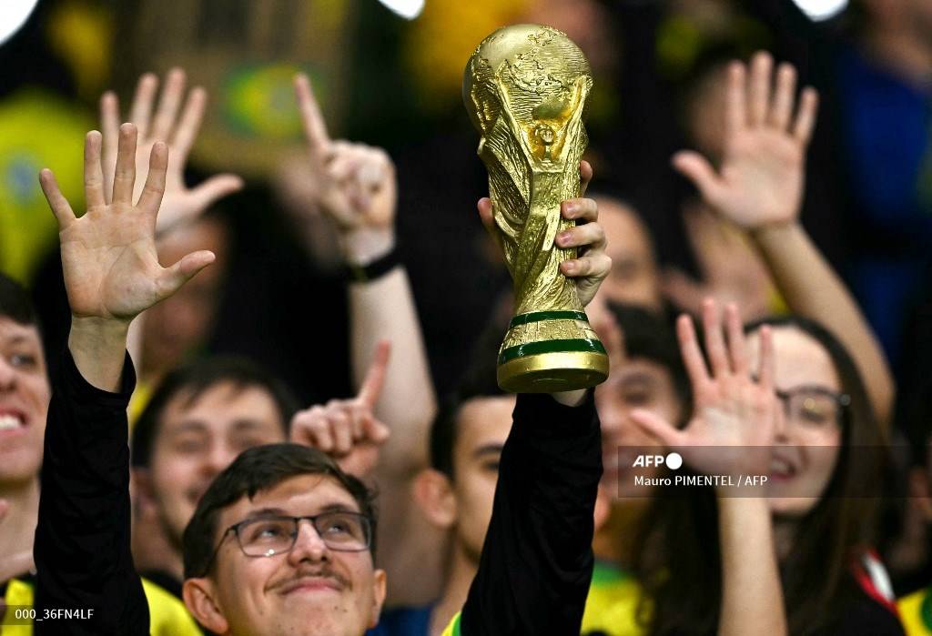 A Brazilian fan holds a replica of the FIFA world cup trophy during the 2026 FIFA World Cup South American qualifiers football match. AFP FILE PIX