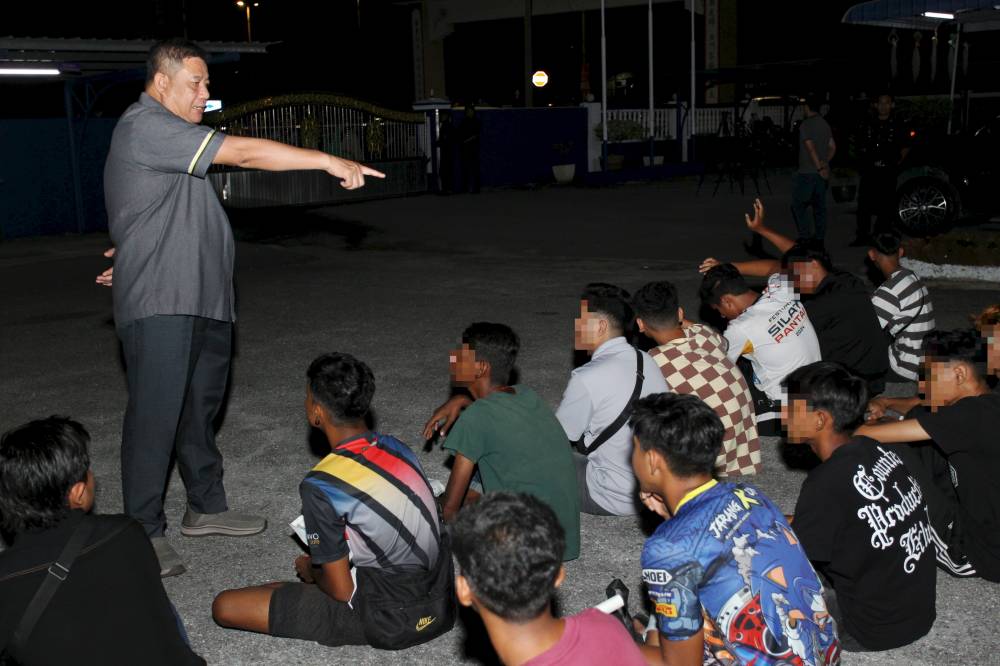 Perak police chief Datuk Azizi Mat Aris giving advice to motorcyclists detained in the Op Samseng operation in Jalan Klebang Ria, yesterday. - Photo to Bernama