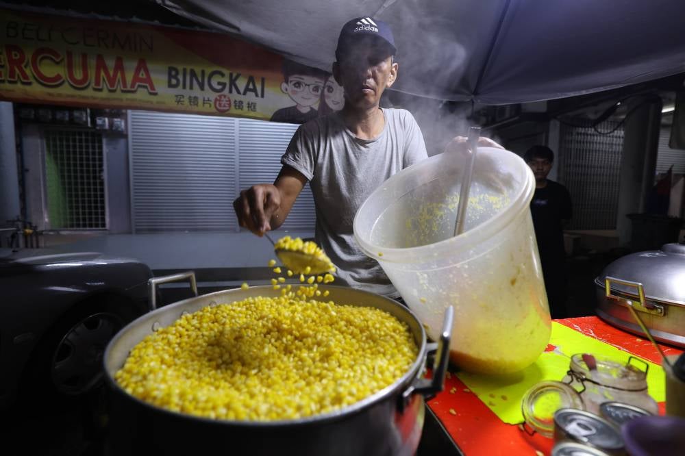 Hasrin said he sells around 600 cups daily, generating a decent profit that has helped supplement his income to raise his five children. Photo by Bernama