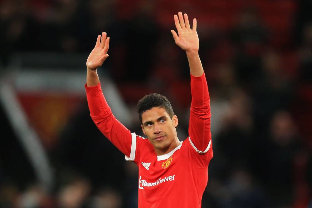 Manchester United's French defender Raphael Varane gestures to supporters on the pitch after the English Premier League football match between Manchester United and Tottenham Hotspur at Old Trafford in Manchester, north west England, on March 12, 2022. - Photo by AFP