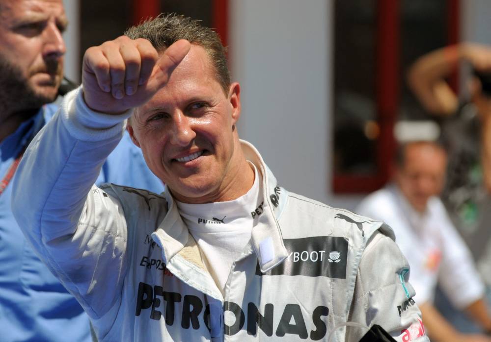 Mercedes' German driver Michael Schumacher celebrates in the parc ferme at the Valencia Street Circuit on June 24, 2012 in Valencia after taking third place of the European Formula One Grand Prix. - File photo by AFP