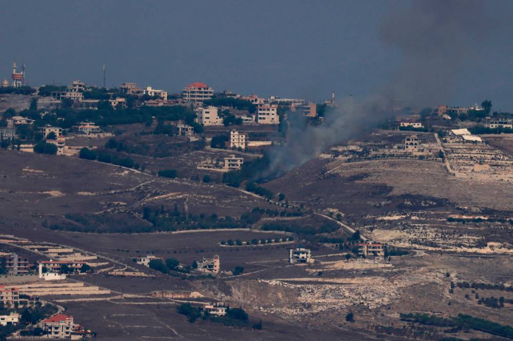 Smoke billowing after Israeli bombardment on the Lebanese village of Maroun El Ras. Photo by Menahem Kahana/AFP