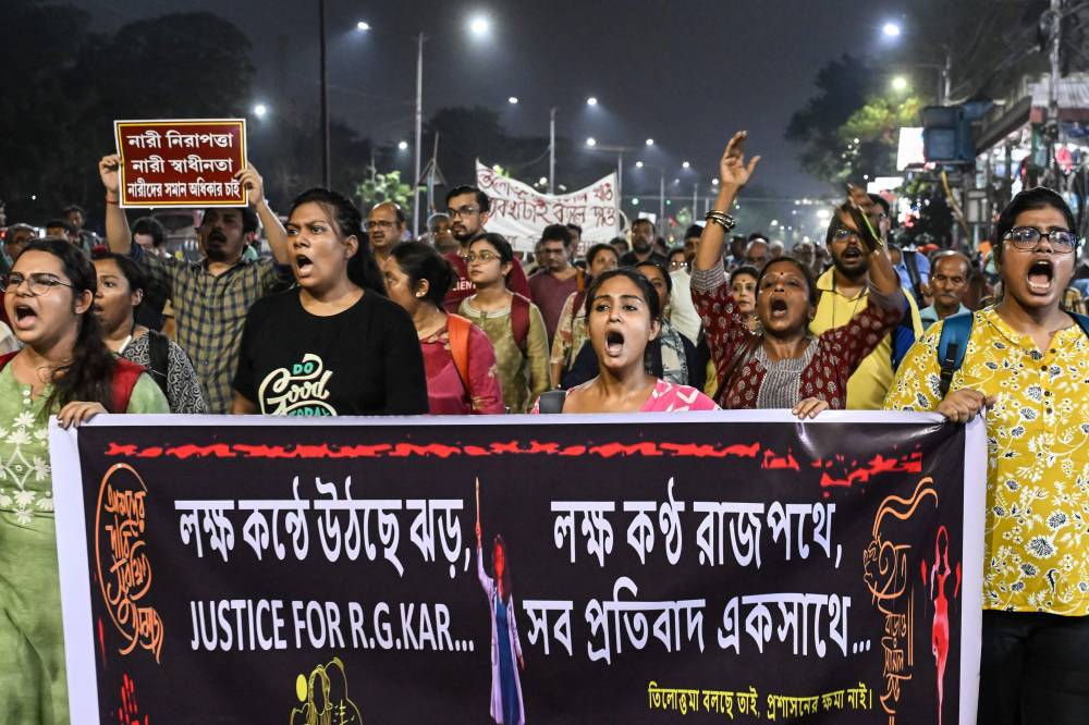 Activists and medical professionals shout slogans during a protest march to condemn the rape and murder of a doctor in Kolkata on October 1, 2024. Indian doctors in Kolkata said on October 1, they had resumed a strike to protest against the brutal rape and murder of a colleague because their demands for hospital safety improvements had not been met. (Photo by AFP)